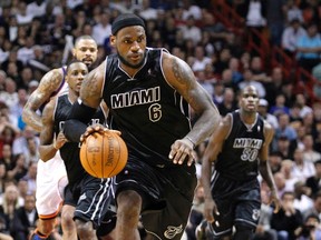 Miami Heat's LeBron James dribbles the ball in the first half of their NBA basketball game against the New York Knicks in Miami, Florida Feb. 23, 2012. (REUTERS/Andrew Innerarity)