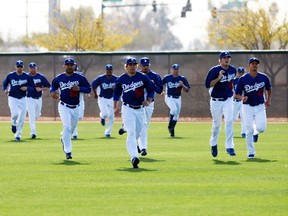 Los Angeles Dodgers pitchers run during a MLB spring training baseball camp in Glendale, Arizona, February 22, 2012. (REUTERS/Rick Scuteri)