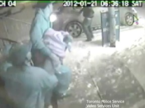 Toronto Police released a surveillance video Tuesday showing friends of Anthony Spencer carrying him out of a Scarborough recording studio and placing him in a car after he was shot Jan. 21.