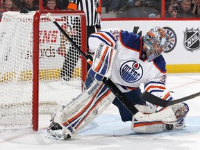 Nikolai Khabibulin makes a pad save during an game against the Ottawa Senators at Scotiabank Place in February. The Oilers netminder is happy to still be a part of the squad following the NHL trade deadline on Feb. 27.
Jana Chytilova/Getty Images