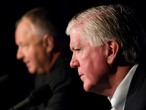 Leafs GM Brian Burke (front) with newly appointed head coach Randy Carlyle at a news conference in Montreal yesterday morning. “If there’s one philosophical commitment that Randy and I share, it’s that I like a rough team.” (Joel Lemay/QMI Agency)