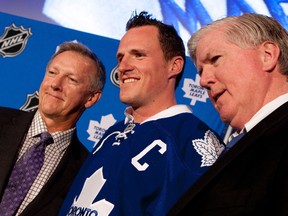 Ron Wilson (left) poses with new captain Dion Phaneuf (centre) and GM Brian Burke on June 14, 2010. (MARK O'NEILL/Toronto Sun files)