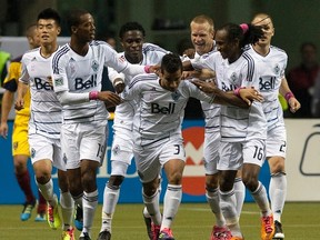 Camilo of the Vancouver Whitecaps is surrounded by teammates after scoring a goal against Real Salt Lake on a penalty kick in Vancouver, British Columbia October 6, 2011.  (REUTERS/Ben Nelms)