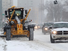 A grader clears snow along Jasper Avenue near 118 Street in Edmonton, Saturday Feb. 25, 2012. 10-15 cm has already fallen in the Edmonton area with a further 2-5 expected Saturday. DAVID BLOOM EDMONTON SUN  QMI AGENCY