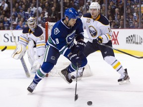 Zack Kassian #9 of the Vancouver Canucks tries to get past Christian Ehrhoff #10 of the Buffalo Sabres as goalie Ryan Miller #30 looks on during the second period in NHL action on March 03, 2012 at Rogers Arena in Vancouver, British Columbia, Canada. (Rich Lam/AFP)