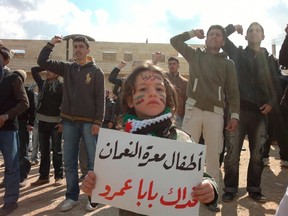 Demonstrators protest against Syria's President Bashar Al-Assad  in Marat al-Numan near the northern province of Idlib March 2, 2012. The bannr reads, "The children Marar Al-Numan, sacrifice our lives for you Bab Amro".  Picture taken March 2, 2012. REUTERS/Handout