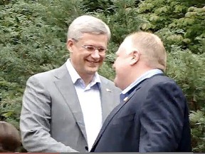 Prime Minister Stephen Harper and Mayor Rob Ford at a barbecue at Ford's home. (YouTube/Toronto Sun files)