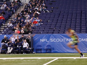Scouts look on as a player runs the 40-yard dash during the 2012 NFL Combine. (Joe Robbins/Getty Images/AFP)