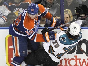 Oilers defenceman Jeff Petry collides with Sharks forward Benn Ferriero at Rexall Place in Edmonton, Alta., March 12, 2012. (DAN RIEDLHUBER/Reuters)