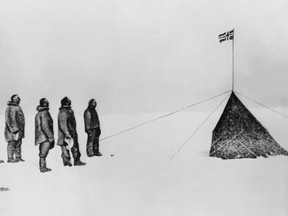 This December 16, 1911 file photo shows Norwegian explorer Roald Amundsen (L) and his companions, Oscar Wisting (2nd L), Sverre Hassel (2nd R) and Helmer Hansen (R), saluting the Norwegian flag at the South Pole which  they were the first to reach on December 14, 1911. QMI Agency/AFP/Stringer