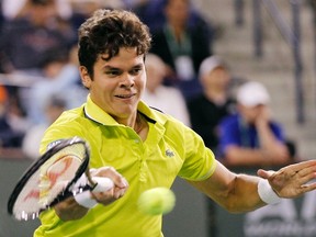 Milos Raonic returns a shot against Roger Federer during their match at the Indian Wells tournament in Indian Wells, Calif., March 13, 2012. (DANNY MOLOSHOK/Reuters)