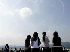 Students watch a performance during the Seoul Air Show Oct. 17, 2005. (You Sung-Ho/Reuters)