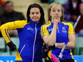 Alberta skip Heather Nedohin (L) reacts to her shot in the last end of the game with third Beth Iskiw during their draw against Yukon/Northwest Territories at the Scotties Tournament of Hearts curling championship in Red Deer, Alberta February 18, 2012. REUTERS/Todd Korol