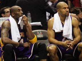 Los Angeles Lakers' Kobe Bryant (L) and Derek Fisher look on during an NBA game earlier this year. (REUTERS)