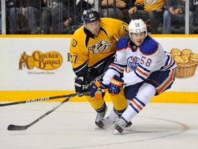 Oilers defenceman Jeff Petry battles Nashville's Patric Hornqvist for the puck Tuesday in Nashville. (AFP)