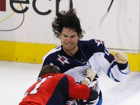 Washington Capitals' Brooks Laich (bottom) and Winnipeg Jets' Jim Slater fight during the second period of their NHL hockey game in Washington March 23, 2012.   
REUTERS/Gary Cameron   (UNITED STATES - Tags: SPORT ICE HOCKEY)