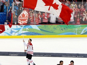 Sidney Crosby carries the Canadian flag after Team Canada won gold at the 2010 Vancouver Olympics.  Canadian-based NHL teams haven't been nearly as successful in recent years. (QMI AGENCY)