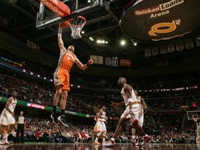 Marcin Gortat of the Phoenix Suns dunks the ball over Antawn Jamison of the Cleveland Cavaliers at The Quicken Loans Arena in Cleveland on Sunday. (GETTY IMAGES)