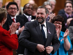 New Democratic Party Leader Thomas Mulcair (C) receives a standing ovation from his caucus during Question Period in the House of Commons on Parliament Hill in Ottawa March 26, 2012.    REUTERS/Chris Wattie