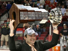 Kootenay Ice owner Jeff Chynoweth hoists the Ed Chynoweth Cup, named after his father and original Ice owner, after his team won the league championship in 2011. (Supplied)