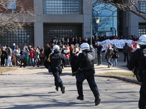 Police blasted students with pepper spray and made several arrests Tuesday after protesters blocked the entrance to the provincial liquor board headquarters. (QMI Agency/Sylvain Denis)