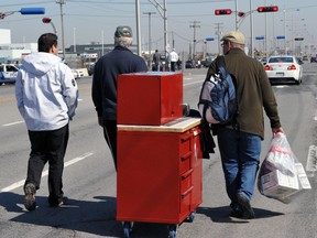 Workers leave an AVEOS plant, March 20, 2012. (QMI Agency/Michel Desbiens)