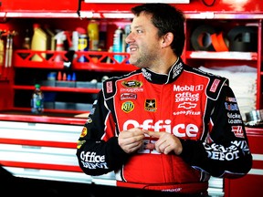 Tony Stewart, driver of the No. 14 Office Depot/Mobil 1 Chevrolet, stands in the garage during practice for Sunday's NASCAR Sprint Cup Series Goody's Fast Relief 500 at Martinsville Speedway in Virginia. (GETTY IMAGES)