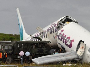 A Caribbean Airlines jet is seen broken at Cheddi Jagan International airport outside Georgetown July 30, 2011. The packed Caribbean Airlines jet carrying 163 people crashed and broke in two as it landed in Guyana at night, injuring several passengers but killing no one. (REUTERS/Neil Marks)