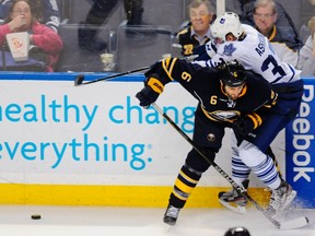 Buffalo Sabres’ Mike Weber (left) collides with Maple Leafs’ Carter Ashton during the second period in Buffalo last night.