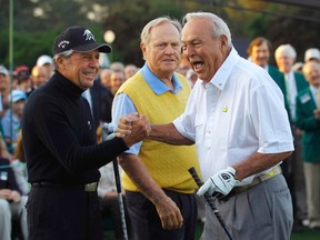 Honorary starter Arnold Palmer (right) is congratulated by fellow golf greats Gary Player (left) and Jack Nicklaus (centre) after hitting his drive during the ceremonial tee-off before first round play in the Masters tournament at Augusta National Golf Club in Augusta, Ga., on Thursday, April 5, 2012. (Brian Snyder/Reuters)