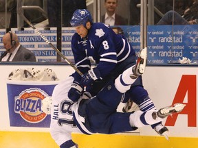 Leafs defenceman Mike Komisarek checks Tampa's Adam Hall during Thursday night's game at the ACC. Leafs on 3-2 in overtime. (STAN BEHAL/Toronto Sun)