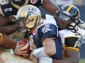 The Tiger-Cats have released import defensive end Stevie Baggs (right). (BRIAN DONOGH/QMI Agency file photo)
