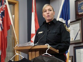 Const. Natalie Aitken discusses March 16, 2012 raids on Hells Angels, showing off clothing seized during Project Flatlined, which displays the Redlined crew's colours. (PAUL TURENNE/Winnipeg Sun)