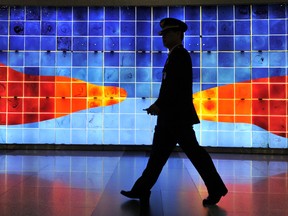 A police man patrols at a shopping centre on March 23, 2012 outside the venue where the 2012 Seoul Nuclear Security Summit will take place.  Leaders from over 50 nations will converge on the South Korean capital for the summit on March 26-27.      AFP PHOTO / NICOLAS ASFOURI