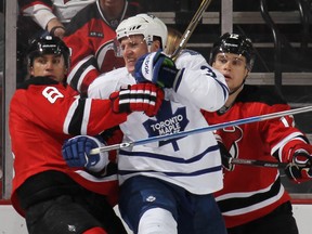 Maple Leafs captain Dion Phaneuf battles with the New Jersey Devils forward Dainius Zubrus on Friday night. “It has been a tough month and a half on everyone,” Phaneuf said of Toronto’s free-fall out of playoff contention. (Getty Images/AFP)