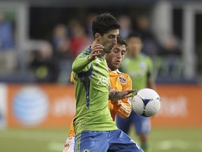 Alvaro Fernandez of the Seattle Sounders battles Colin Clark of the Houston Dynamo at CenturyLink Field on March 23, 2012 in Seattle, Washington. (Otto Greule Jr/Getty Images/AFP)