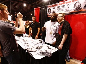 Fans surround MMA fighters King Mo (white t-shirt) and Jake Shields (background) during an Fan Expo in Toronto two years ago. (SUN FILE PHOTO)