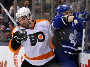 Philadelphia Flyers defenceman Marc-Andre Bourdon splatters Toronto Maple Leafs forward Mikhail Grabovski against the glass during Thursday night's 7-1 Philly win at the ACC. (REUTERS)