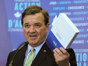Finance Minister Jim Flaherty speaks to the media before delivering Canada's Economic Action Plan to the House of Commons. (Andre Forget / QMI AGENCY)
