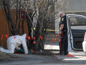 Winnipeg police investigate after the body of a woman was found near a dumpster behind an apartment block in the 700-block of Notre Dame Avenue in Winnipeg on Saturday, March 31, 2012. (Courtesy Stan Milosevic)