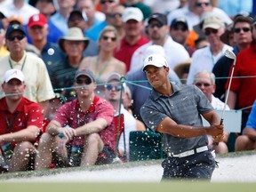 Tiger Woods hits from a sand trap on the seventh green during first-round play in the 2012 Masters Golf Tournament at the Augusta National Golf Club in Augusta, Georgia, April 5, 2012. (REUTERS/Phil Noble)