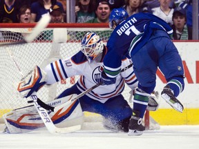 Vancouver's David Booth fires a puck past Edmonton goalie Devan Dubnyk Saturday night. (Rich Lam, Getty Images)
