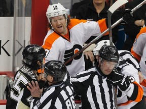 Linesmen try to separate Pens forward Arron Asham (45) from Flyers' Scott Hartnell and Zac Rinaldo during NHL action in Pittsburgh on April 1, 2012. (Jason Cohn/Reuters)