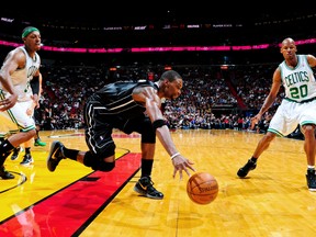 Heats' Chris Bosh goes for a loose ball against Paul Pierce (34) and Ray Allen  of the Celtics during Boston's huge win Monday night in Miami. (GETTY IMAGES)