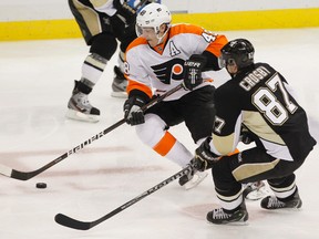 Penguins forward Sidney Crosby skates against Flyers forward Danny Briere during Game 1 of their NHL Eastern Conference quarterfinal series at the Consol Energy Center in Pittsburgh, Penn., April 11, 2012. (JASON COHN/Reuters)