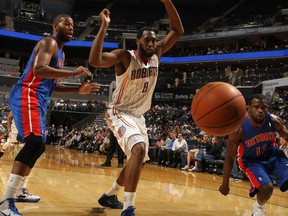 DJ White of the Charlotte Bobcats, Will Bynum and Greg Monroe of the Detroit Pistons look at a loose basketball during the game at the Time Warner Cable Arena on April 12, 2012 in Charlotte, North Carolina. (Kent Smith/NBAE via Getty Images/AFP)