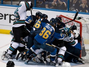 Players from the San Jose Sharks and St. Louis Blues pile into the Blues net during their NHL Western Conference quarterfinal game in St. Louis. (Sarah Conrad/REUTERS)