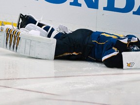 Blues goaltender Jaroslav Halak lies on the ice after being hit by teammate Barret Jackman during Game 2 of their NHL Western Conference quarterfinal series against the Sharks at the Scottrade Center in St. Louis, Miss., April 14, 2012. (SARAH CONARD/Reuters)