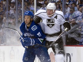 Manny Malhotra, of the Vancouver Canucks, and Matt Greene, of the Los Angeles Kings, react after colliding behind the net during the second period in Game 2 of the Western Conference Quarterfinals during the 2012 NHL Stanley Cup Playoffs at Rogers Arena on April 13, 2012 in Vancouver, British Columbia, Canada. (Rich Lam/Getty Images/AFP)