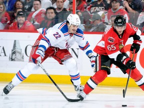 Erik Karlsson, of the Ottawa Senators, skates with the puck while being chased by Brian Boyle, of the New York Rangers, in Game 3 of the Eastern Conference Quarterfinals during the 2012 NHL Stanley Cup Playoffs at the Scotiabank Place on April 16, 2012 in Ottawa, Ontario, Canada. (Richard Wolowicz/Getty Images/AFP)